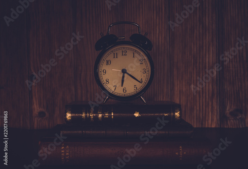 vintage alarm clock on wooden background