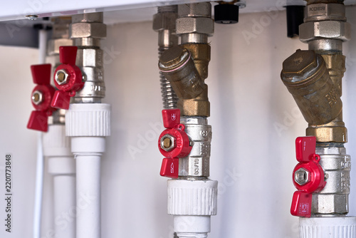 Close-up of wall-mounted gas boiler pipes.