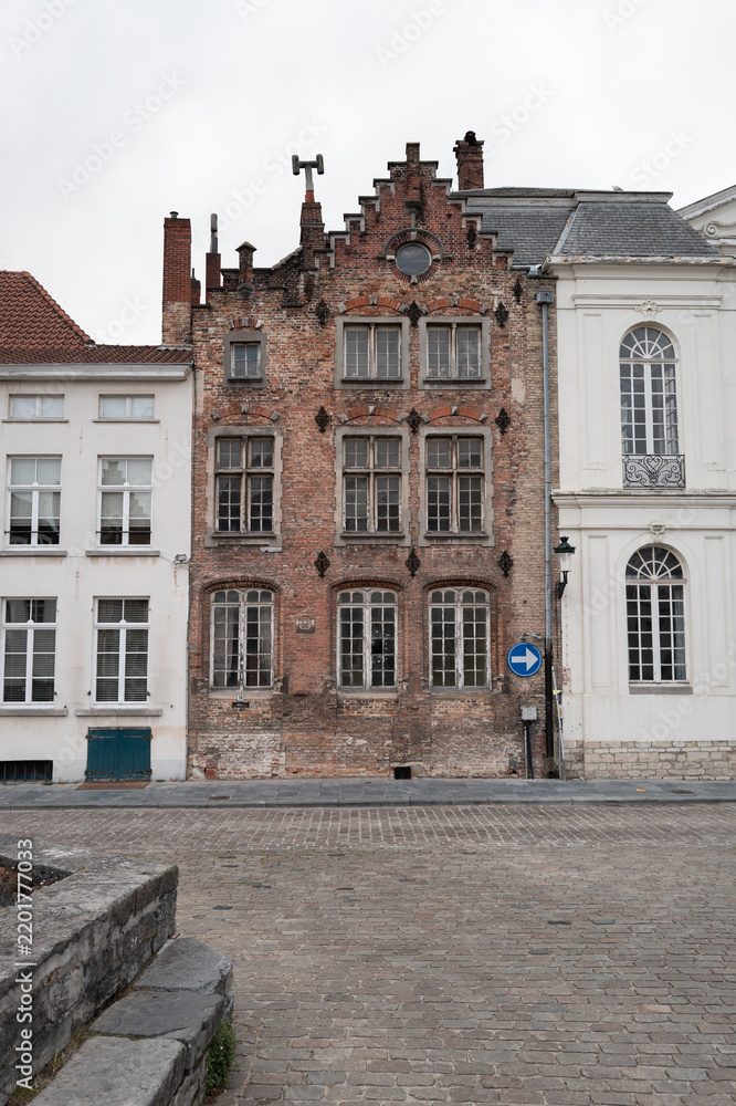 Obraz premium Bruges historic brick building with white front neighbors