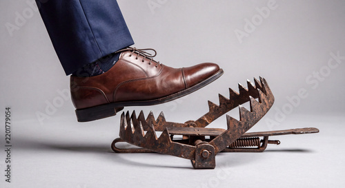 red business boots walking in a trap on a white background