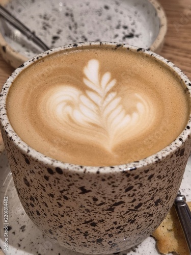 Canvastavla Detailed view of a creamy cappuccino poured into a handmade speckled ceramic mug