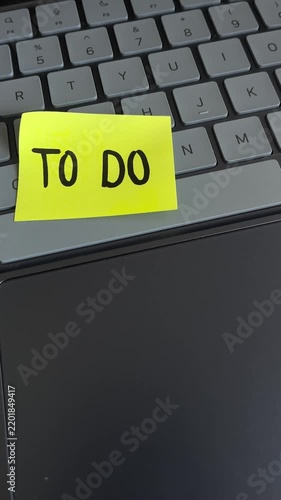 Digital to do list sticky note on laptop keyboard
