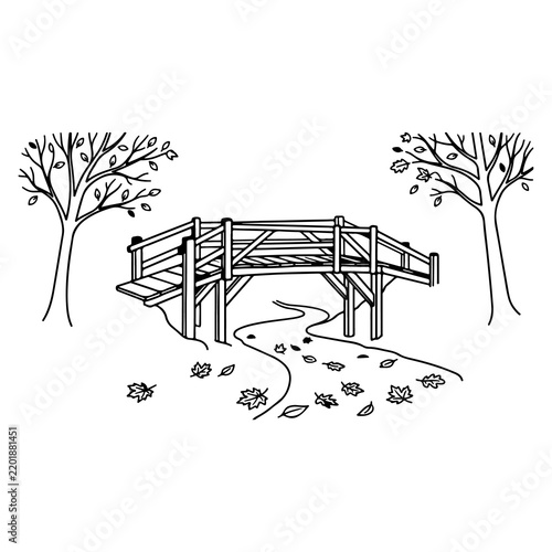 Simple wooden bridge over a winding path in autumn