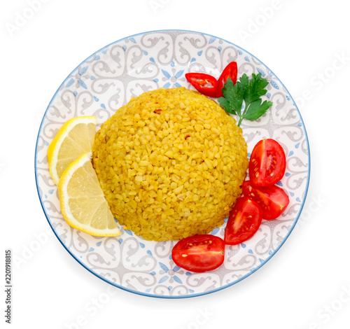 Obraz na płótnie Delicious bulgur with tomatoes, lemon slices and parsley isolated on white, top