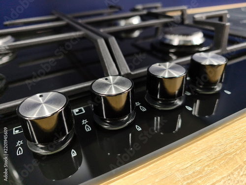 Close view of burner control knobs on gas stove, modern household appliance in hardware store, precise regulation for oven and hob in domestic kitchen