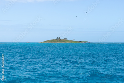 Фотография Water surrounds a small island in Abrolhos, Bahia, Brazil on a clear day