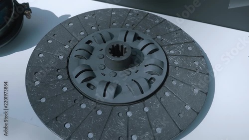 Samples of new automotive clutch baskets and discs for them are presented at the exhibition. Closeup. Shot in motion