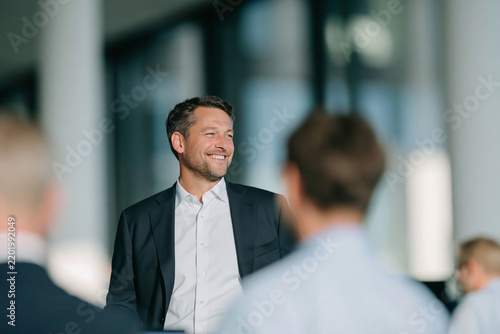 Smiling Business Leader During Corporate Team Meeting