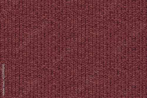 A full-frame, detailed close-up shot of wine red color knitted wool fabric texture. Characteristic vertical ribbed knit pattern and soft yarn fibers. Top down view