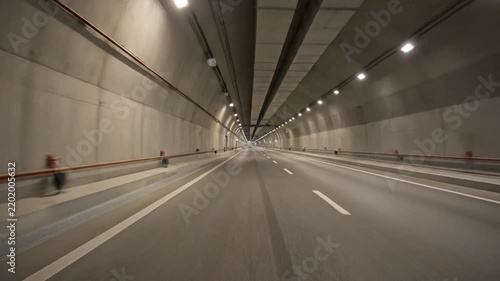 The impressive interior of a contemporary road tunnel, with bright overhead lighting illuminating the path for seamless vehicular transit and modern infrastructure