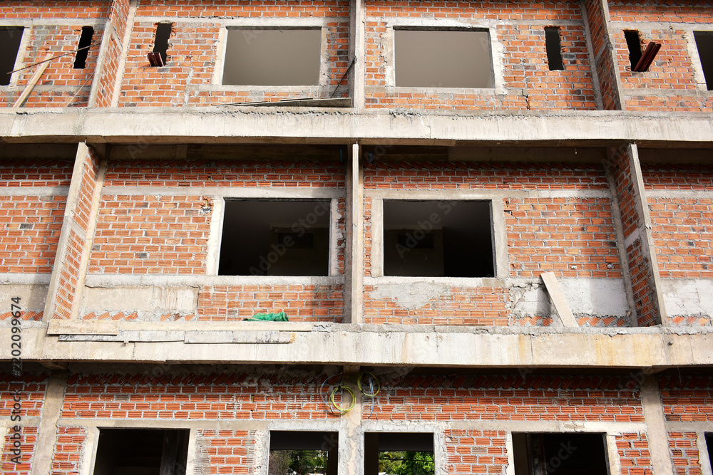 Fototapeta premium exterior view of brick house under construction with concrete structure
