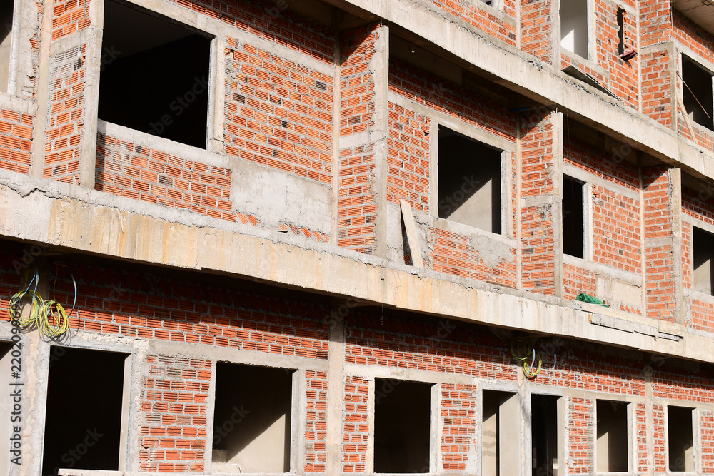 Obraz premium exterior view of brick house under construction with concrete structure