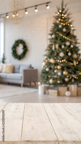 Wooden tabletop with blurry christmas tree and festive interior background