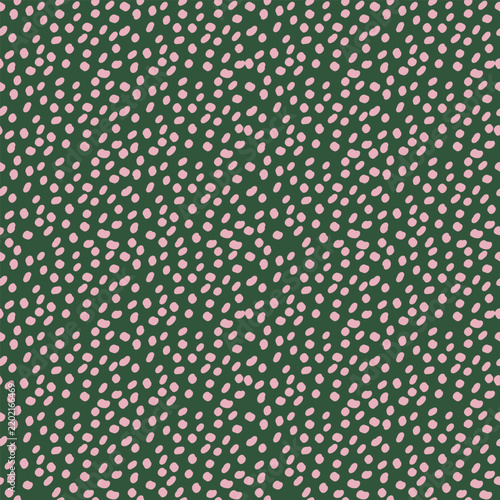 Seamless pattern with hand drawn irregular pink dots on dark green background. Abstract cute spotted texture vector illustration for fabric textile print, wrapping paper, and retro wallpaper design.