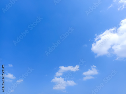 Cumulus clouds in the sky are abstract and aesthetic, with a blue sky background. Cumulus clouds are white clouds that have a flat base so they look very soft and fluffy