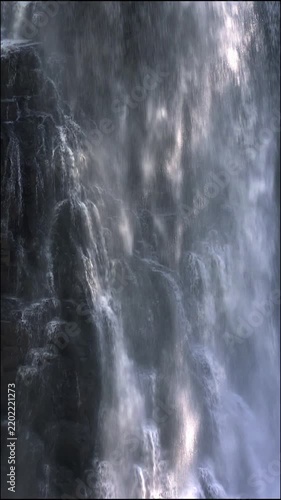 Backlit Curtain of Falling Water Close Up Vertical Video