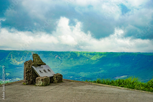 Fotografie Daikanbo Viewpoint monument overlooking the vast Aso caldera under dramatic clou