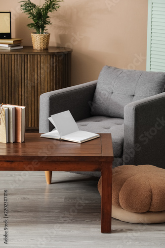 Mindfulness and relaxation, open book on coffee table in cozy living room int...