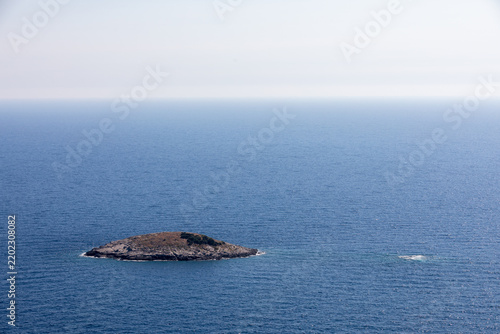 A tiny island surrounded by the crystal-clear waters of the Mediterranean sea, offering a peaceful and picturesque coastal landscape.