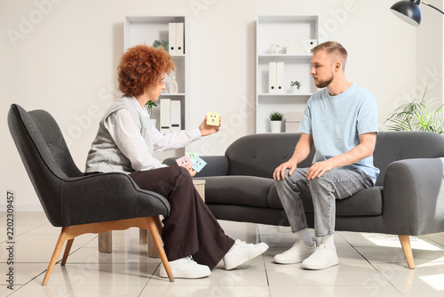 Mental health therapy and emotional intelligence, psychologist using sticky n...