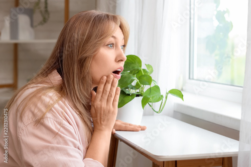 Obraz na plátne Surprise and shock, woman looking out of a window with an astonished expression