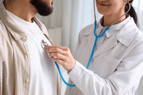 Medical checkup and health screening, doctor using stethoscope to examine pat...