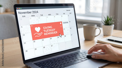 Giving Tuesday calendar reminder on a laptop screen with coffee  