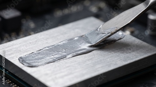 Computer technician applying thermal paste to cpu heatsink in clean workspace