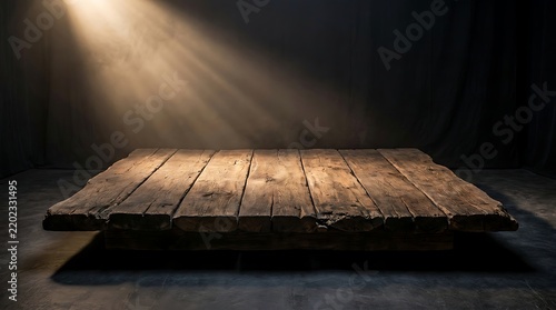 Old wooden platform lit by a single beam of light