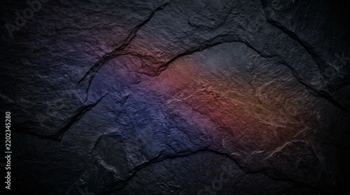 Dark stone texture with blue and orange light reflections