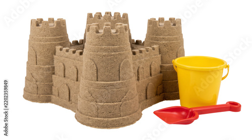Detailed sandcastle with towers yellow bucket and red shovel