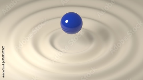 Blue sphere suspended in beige ripples