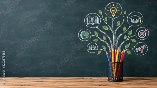 Creative learning and educational growth concept with chalk tree drawing academic icons and colored pencils