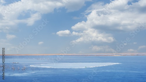 frozen lake at the bright cold day, winter outdoor landscape time lapse scene