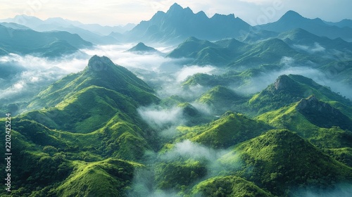 Aerial View Of Lush Green Mountains Covered In Morning Mist With Dramatic Sunlight In The Valley