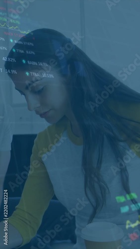 Vertical video: Woman reviewing stocks at desk, overlay fading in and animating charts with taps
