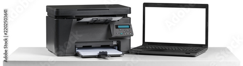 Printer and laptop on a white table in a workspace