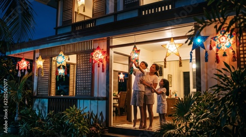 Filipino family hanging parol star lanterns for Christmas