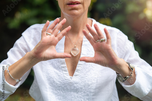 Coherence: mindfulness coach holding hands open outdoors, expressing emotional balance, inner alignment, focused awareness and spiritual harmony.