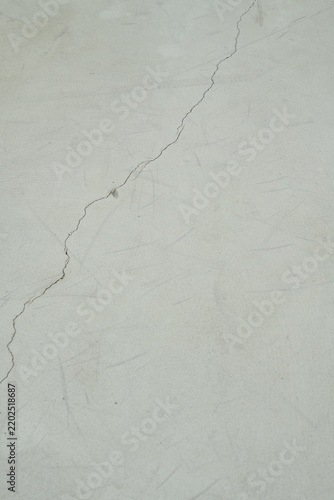 Weathered painted concrete surface of an outdoor basketball court with fine cracks and green, blue and turquoise tones, suitable for sports backgrounds, textures and abstract designs.