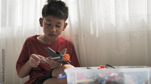 Child Playing with Building Blocks Indoors