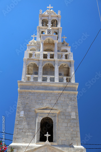 The ornate white bell tower of the Church of St. John in the harbor town of Yialos on the Greek island of Symi.