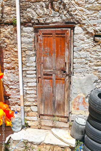 Old, worn wooden door on a house, Symi Island, Greece.