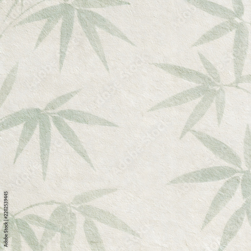 Soft watercolor bamboo leaves background on textured paper