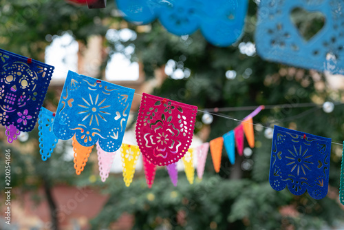 Mexican Culture Festive Decoration with Papel Picado Banners for Cinco de Mayo Celebration. Detailed outdoor view capturing festive Latin American paper bunting  