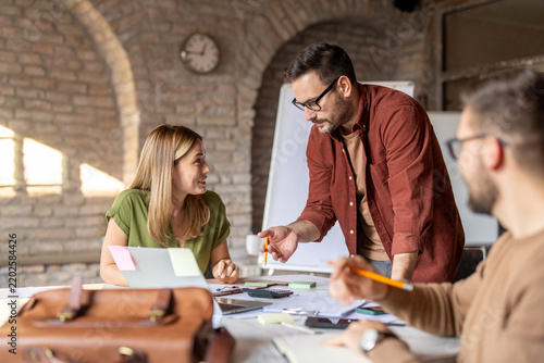Small business team working together and collaborating at office desk