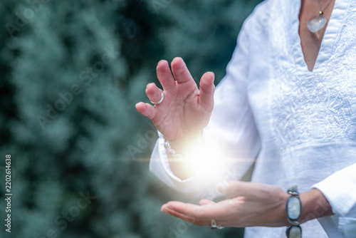 Mindfulness practice channeling healing light between the hands, spiritual energy meditation