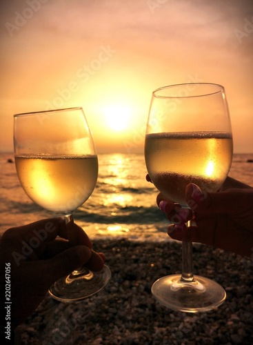 Fotografie Couple is drinking white whine during sea sunset