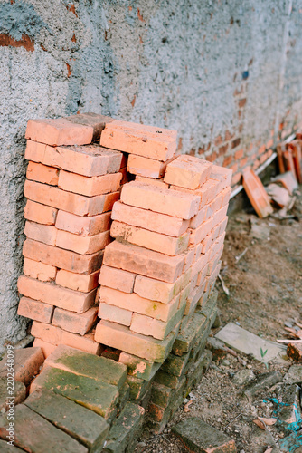 Stack of Orange Clay Bricks at Construction Site