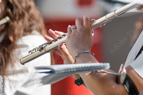 Close-Up of Musician Playing Silver Flute Outdoors at Concert